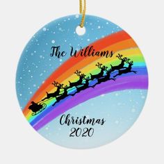 a christmas ornament with santa's sleigh and rainbow