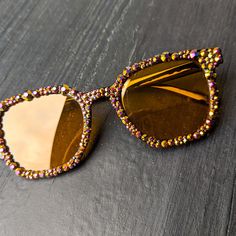 Material of glasses:Plastic Frame Color: Black Frame Shape: Square Lens Color: Yellow Crystal Color: Golden Pink Metallic Note: These are fashion glasses. Not intended to protect eyes against strong sunlight.  ✨Every stone is placed by hand and each pair is one of a kind. Individually adorned with dazzling rhinestones, these sunglasses create a radiant sparkle that catches every eye. ✨ 💕Every pair comes with a microfiber pouch to keep your shades safe and can be used for a quick, easy cleaning. Party Sunglasses With Anti-reflective Glass, Gold Anti-reflective Sunglasses For Parties, Brown Plastic Party Sunglasses, Yellow Glass Sunglasses For Party, Handmade Sunglasses, Tree Jewelry, Pink Metallic, Fashion Glasses, Jewelry Tree