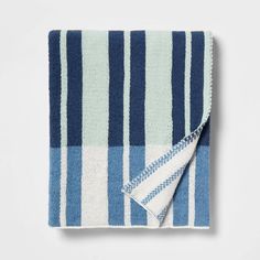 a blue and white striped towel folded on top of a table