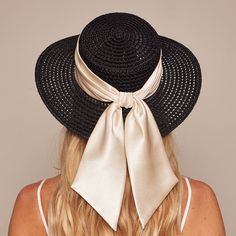 Black textured hemp boater with ivory shiny satin ruched band and tails. Measurements: 6.5" X 2.75" X 3.25" One Size. SKU: 21018-13124 Chic Brimmed Boater Hat With Bow, Chic Boater Hat With Curved Brim And Bow, Chic Boater Hat With Bow And Curved Brim, Chic Short Brim Straw Hat With Bow, Chic Straw Hat With Bow And Short Brim, Elegant Brimmed Sun Hat With Bow, Chic Straw Hat With Bow, Chic Straw Hat With Bow For Kentucky Derby, Chic Kentucky Derby Straw Hat With Bow