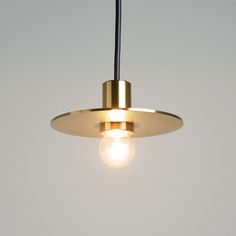 a light that is hanging from the ceiling with a white wall in the back ground