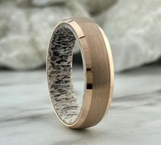 a wedding ring with an antelope print in it's center is shown