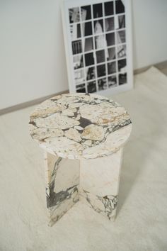 a marble table sitting on top of a white rug