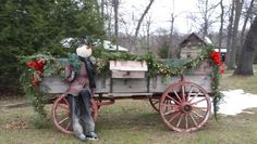 an old fashioned christmas wagon with decorations on it