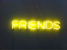 a neon sign that says friends on it