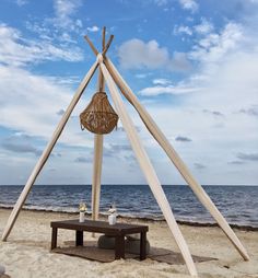 a wooden structure sitting on top of a sandy beach