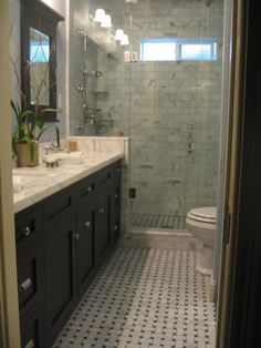 a white toilet sitting next to a walk in shower under a bathroom mirror above a sink