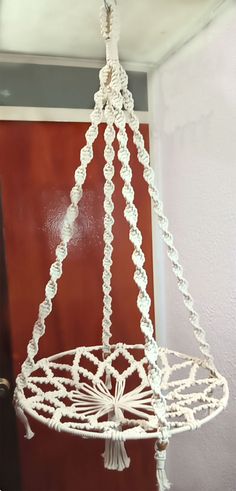 a white macrame hanging from the ceiling