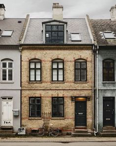 two buildings with bicycles parked in front of them