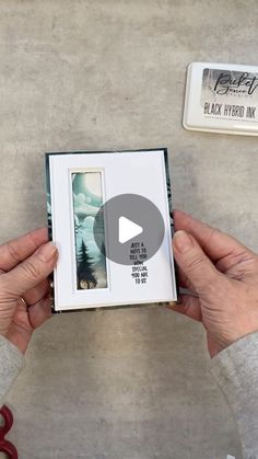 two hands holding an open photo album