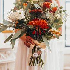 a woman holding a bouquet of flowers in her hands