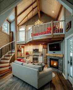 a living room filled with furniture and a fire place in the middle of a room