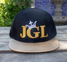 new El Chapo Guzman JGL embroidered  hat Gold Snapback Baseball Cap For Streetwear, Adjustable Hats With Custom Logo For Streetwear, Gold Snapback Trucker Hat, Gold Snapback Baseball Cap, Gold Snapback Hat With Adjustable Flat Brim, Adjustable Baseball Cap With Embroidered Logo And Flat Crown, Adjustable Gold Snapback Hat With Flat Brim, Adjustable Flat Crown Baseball Cap With Embroidered Logo, Gold Adjustable Flat Bill Baseball Cap