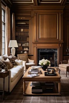 a living room filled with furniture and a fire place in front of a book shelf