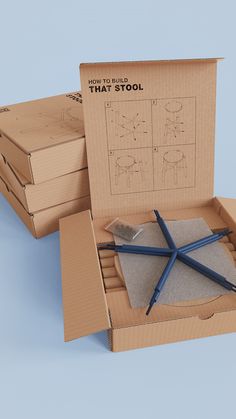 three cardboard boxes with different types of scissors in them