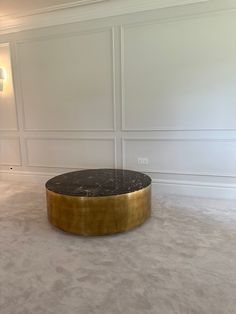 a black and gold coffee table in an empty room