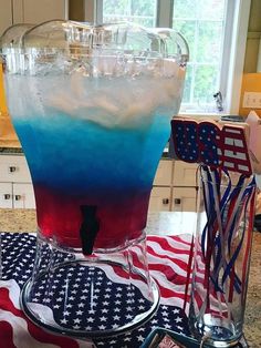 a blue and red drink sitting on top of a counter next to an american flag table cloth