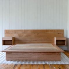 a bed that is made out of wood and has no headboard or foot board