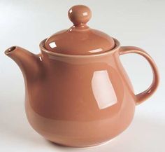 a brown ceramic tea pot with a lid