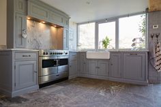 Traditional painted bespoke mantle over stainless steel range cooker with ceramic belfast sink in l shape configuration Farmhouse Kitchen Design