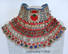 Vintage handmade Kuchi Nomad Tribal-Choker with mostly red and green glass jewels and a layer of dangling coinpendants with a glass jewel on each dangle. This Tribal-Choker is vintage but in an excellent condition. It has still the old lining and maybe you want to renew or to cover it with new fabric. From the weight you can tell that this is one of the old excellent handicraft quality ones. Lenght 31 cm / 12.20 ", hight 14 cm / 5.51 " Weight 388 g This is real vintage authentic Kuchi nomad jewe Handmade Eclectic Red Jewelry, Red Festival Jewelry, One Of A Kind Red Jewelry For Festivals, Red Vintage Jewelry For Festivals, Vintage Red Jewelry For Festivals, Red Bohemian Jeweled Jewelry, Bohemian Red Jeweled Jewelry, Afghan Jewelry, Afghan Fashion