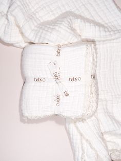 a white blanket and two pillows on top of each other with words written on them