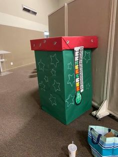 a green shopping bag sitting on the floor next to a cooler in an office building