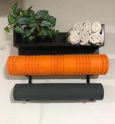 an orange yoga mat sitting on top of a black shelf