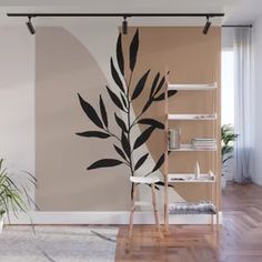 a living room with a plant on the wall next to a chair and shelf in front of it