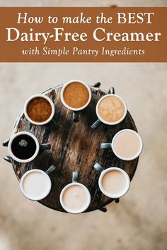 coffee cups sitting on top of a wooden table with text overlay that reads how to make the best dairy - free creamer with simple pantry ingredients