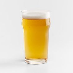 a glass of beer sitting on top of a table