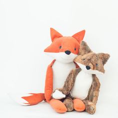 two stuffed animals sitting next to each other