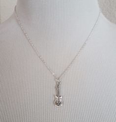 "Personalized Silver Guitar Necklace! A detailed three dimensional electric guitar charm on a bright silver chain makes the perfect gift for you or your favorite musician. The guitar charm is made from zinc alloy and measures 30 mm by 10 mm. The chain is silver plated and measures 16\" or 18\" with a 1\" extender. You can also personalize your necklace with a .5\" silver plated disc stamped with the initial of your choice (see last picture). To order your necklace WITHOUT a custom stamped initia Silver Music-themed Metal Necklace, Nickel-free Silver Jewelry For Concerts, Sterling Silver Jewelry For Concerts, Nickel-free Silver Music-themed Necklaces, Music-themed Silver Pendant Necklace, Nickel-free Sterling Silver Music-themed Necklace, Guitar Necklace, Silver Trumpet, Silver Guitar