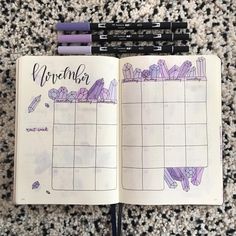 an open planner with purple markers on it