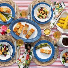 an overhead view of food on plates and placemats, with wine in the foreground