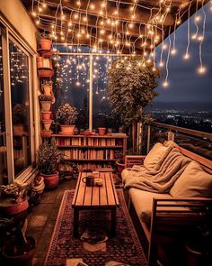 a balcony with lights strung from the ceiling and potted plants on the windowsill