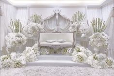 a white room decorated with flowers and furniture