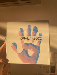 a person holding up a handprinted sign with the date 09 - 05 - 22