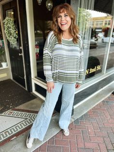 Stay stylish and comfy with our Olive Stripe Slouch Tee. This oversized, long sleeve shirt features a ribbed texture and round neck, perfect for a casual and relaxed look. (Pun intended) Get ready to slouch in style! Made in the USA Casual Slouchy Sweater With Ribbed Cuffs, Relaxed Long Sleeve Slouchy Tops, Soft-washed Oversized Everyday Tops, Cheap Striped Relaxed Fit T-shirt, Striped Long Sleeve Relaxed Fit T-shirt, Oversized Long Sleeve Shirt, Maxi Jumpsuit, Oversized Long Sleeve, All American Girl