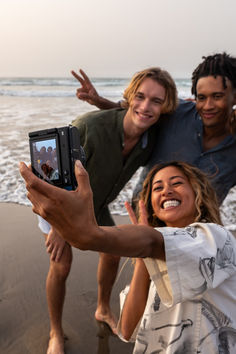 three people taking a selfie on the beach