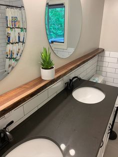 a bathroom with two sinks and a mirror