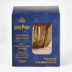 a harry potter golden snitch hot chocolate bomb in a blue box on a white background