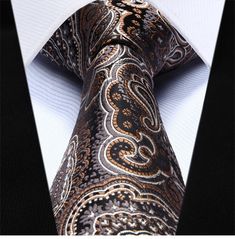 Brown and White Paisley Necktie Take your look up a level with this elaborate brown paisley necktie with detailed accents. Choose From: Single Tie Tie and Pocket Square Material of Tie: 100% Silk Dimensions of Pocket Square: 10.5” Inches x 10.5” Inches Length of Tie: Regular (60”) XL (63”) Width of Tie: 3.4" Inches Pattern On Fabric: Stitched Paisley Color Of Fabric: Brown Elegant Multicolor Paisley Print Suit And Tie Accessories, Elegant Patterned Neckwear With Ties, Elegant Brown Tie For Semi-formal Events, Elegant Multicolor Neckwear With Ties, Elegant Multicolor Formal Neckwear, Elegant Multicolor Neckwear For Business, Elegant Multicolor Business Neckwear, Classic Brown Neckwear With Ties, Multicolor Paisley Print Suit And Tie Accessories For Business