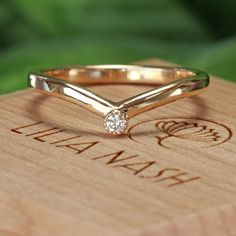 a diamond ring sitting on top of a wooden box