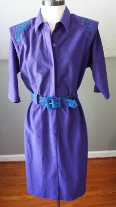 "Here is a wonderful short sleeve dress by S.L. Fashions. 100% polyester and made in the USA. Vivid purple fabric with green and blue floral accents on the shoulders, and matching green and blue belt. Four button front in the blouse section, 7\" zipper in the front of the skirt section. Shoulder pads present. It's in excellent shape with tons of life left! The tag says size 12, but here are the exact measurements. (be sure to reference the last photo to see how I measure dresses) Here are the me Fitted Belted Purple Dress, Blue Belt, Vintage Short, Purple Fabric, Vintage Shorts, Short Sleeve Dress, Green And Blue, Dress Clothes For Women, Shoulder Pads