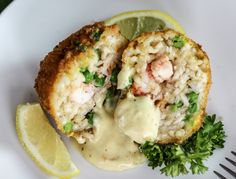 a white plate topped with crab cakes covered in sauce