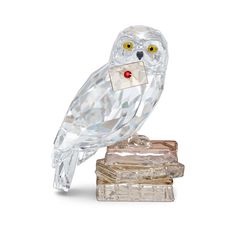 an owl figurine sitting on top of some books