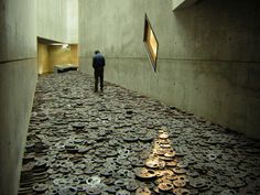 there is a man standing in the middle of a room with lots of coins on the floor