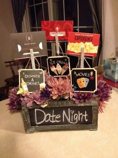 a sign that says date night with flowers in front of it and other signs on the table