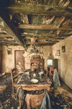 an old room with a table and chairs that has been burned out in the fire